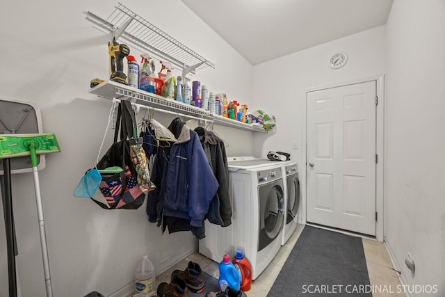 laundry room featuring laundry area, washing machine and dryer, baseboards, and light tile patterned flooring