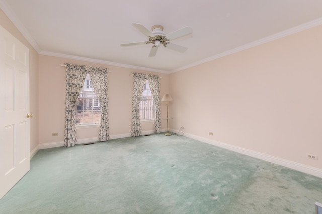 unfurnished room with carpet flooring, crown molding, baseboards, and ceiling fan