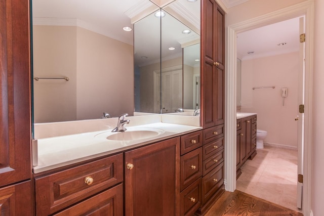 bathroom with recessed lighting, crown molding, vanity, and toilet