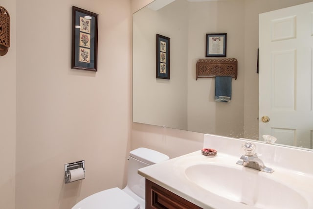 half bathroom featuring toilet and vanity