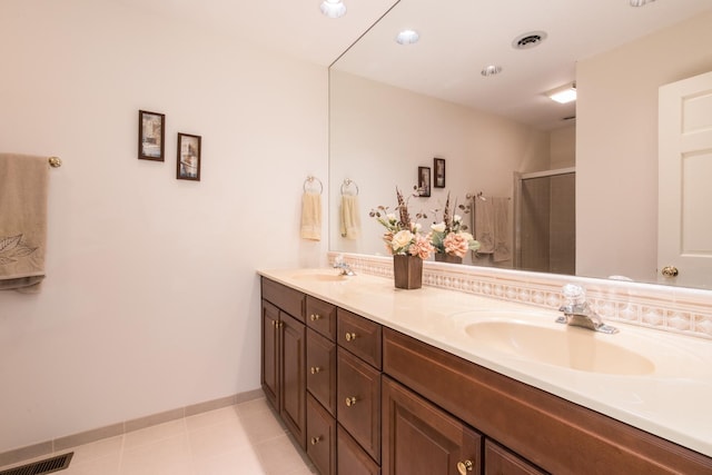 bathroom with a shower stall, visible vents, and a sink