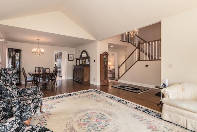 living room with high vaulted ceiling, wood finished floors, baseboards, stairs, and an inviting chandelier