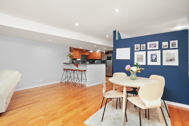 dining space with light wood-type flooring