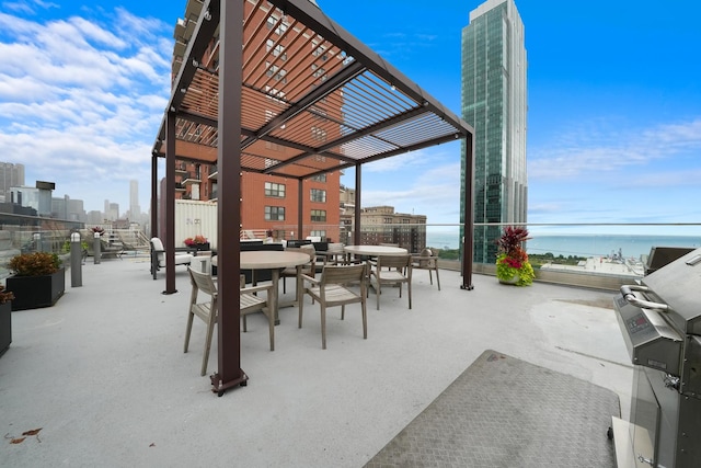 view of patio featuring a pergola, grilling area, and a water view