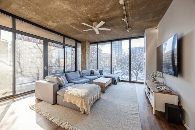 sunroom featuring ceiling fan and plenty of natural light