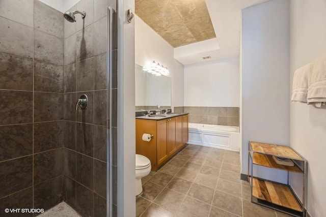 full bathroom featuring separate shower and tub, vanity, and toilet