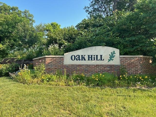 community / neighborhood sign with a lawn