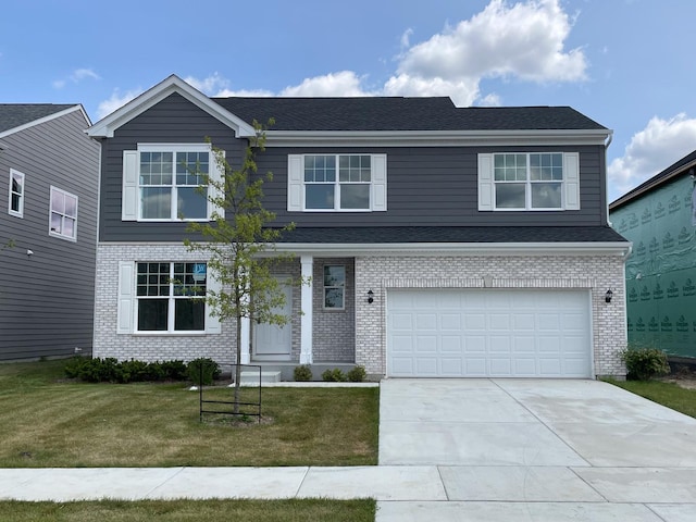 view of front of home with a front yard and a garage