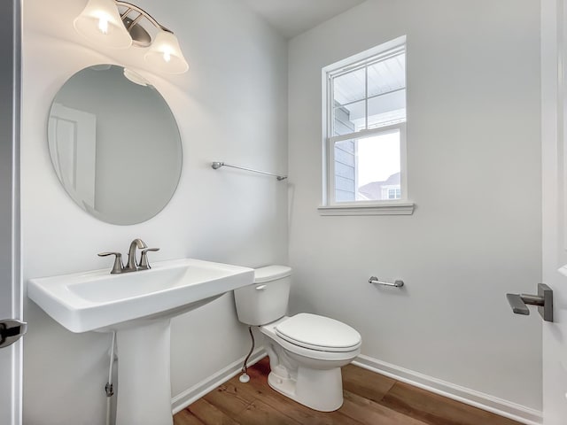 bathroom featuring hardwood / wood-style floors, toilet, and sink