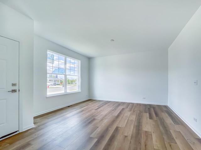 spare room with light hardwood / wood-style floors