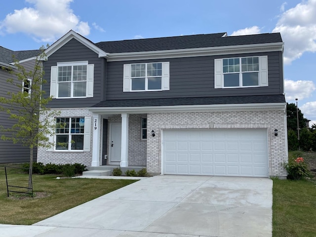 view of front of property with a front yard and a garage