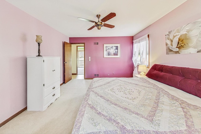 bedroom featuring ceiling fan, light colored carpet, and multiple windows