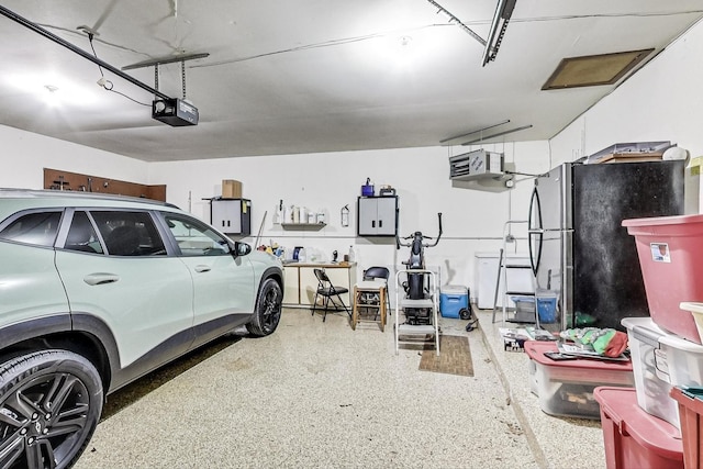 garage with black fridge and a garage door opener