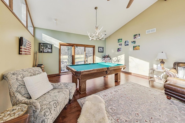 game room featuring high vaulted ceiling, ceiling fan with notable chandelier, dark wood-type flooring, and pool table