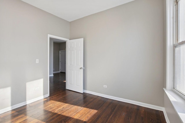 empty room featuring dark hardwood / wood-style flooring