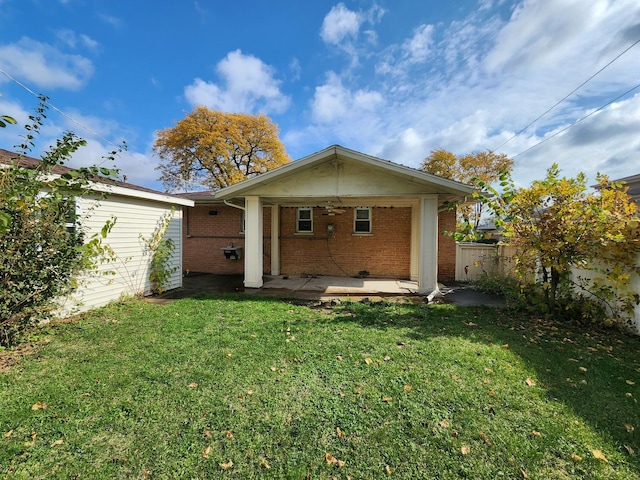 rear view of house featuring a lawn