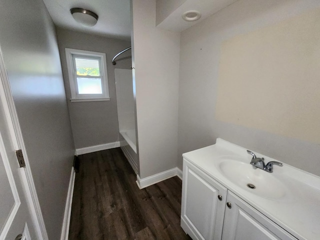 bathroom featuring vanity, tub / shower combination, and hardwood / wood-style flooring