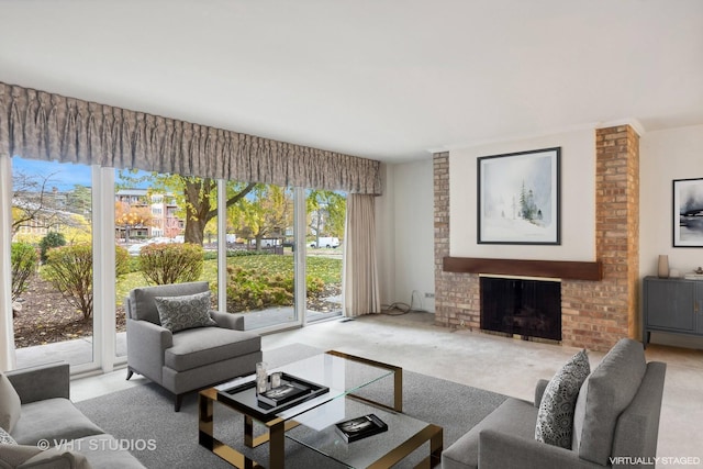 carpeted living room featuring plenty of natural light, baseboard heating, and a brick fireplace