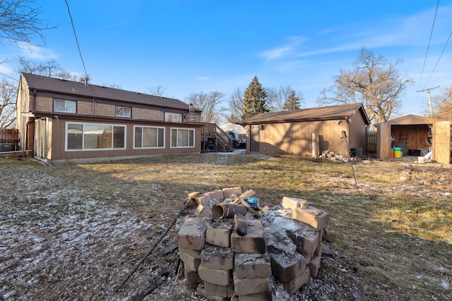 rear view of property featuring an outdoor structure