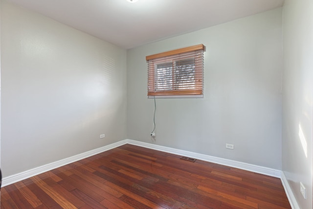 empty room with dark hardwood / wood-style floors