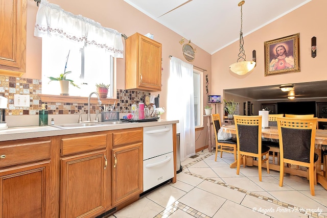 kitchen with decorative backsplash, pendant lighting, a healthy amount of sunlight, and sink