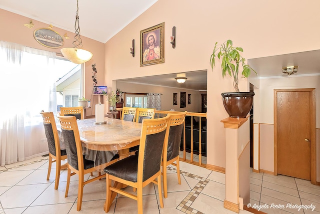 tiled dining space with lofted ceiling