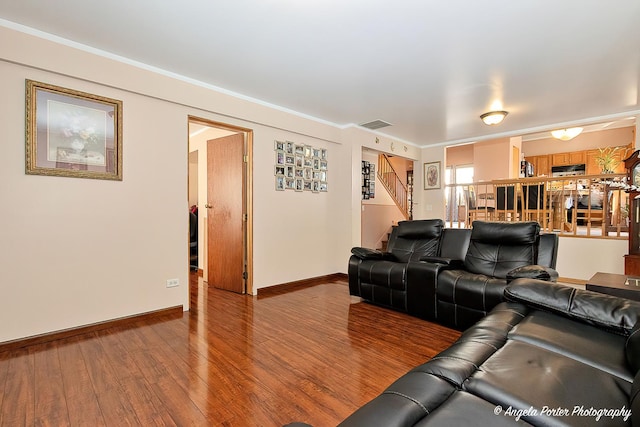 cinema featuring hardwood / wood-style flooring and ornamental molding