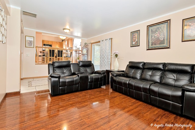 living room featuring crown molding and hardwood / wood-style floors