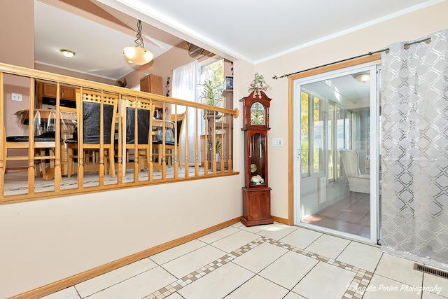 interior space featuring tile patterned floors, plenty of natural light, and ornamental molding