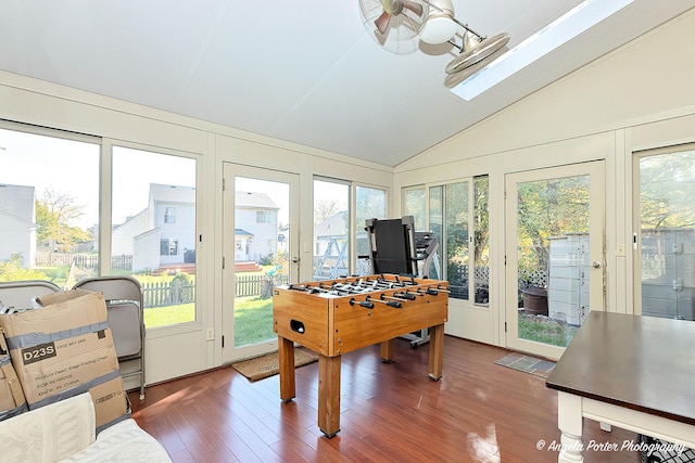 rec room featuring lofted ceiling, dark hardwood / wood-style flooring, ceiling fan, and plenty of natural light