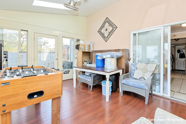 rec room featuring hardwood / wood-style flooring and vaulted ceiling