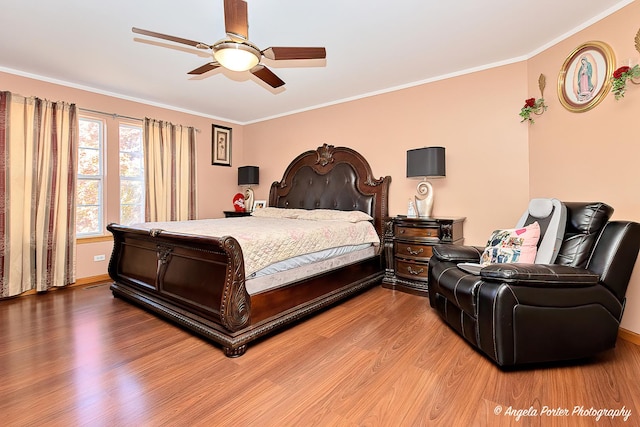 bedroom featuring hardwood / wood-style floors, ceiling fan, and crown molding