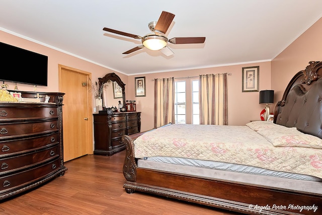 bedroom with ceiling fan, ornamental molding, and hardwood / wood-style flooring