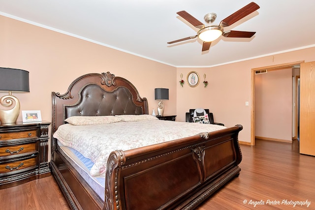 bedroom with ceiling fan, crown molding, and wood-type flooring