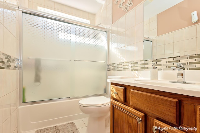 full bathroom with enclosed tub / shower combo, tile patterned floors, toilet, decorative backsplash, and vanity