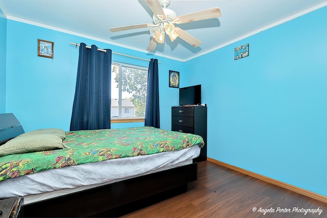 bedroom with ceiling fan, dark hardwood / wood-style floors, and crown molding