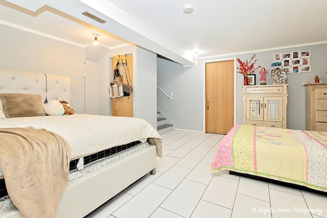 tiled bedroom featuring ornamental molding