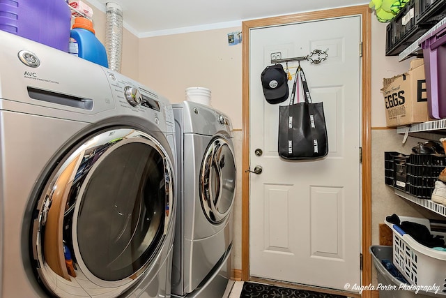 clothes washing area with washing machine and dryer