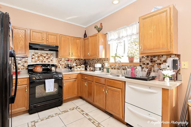 kitchen with sink, backsplash, crown molding, light tile patterned flooring, and black appliances