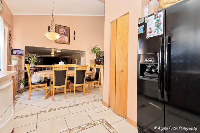 dining area featuring light tile patterned floors and crown molding