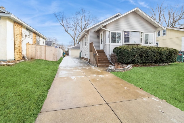 view of front of home with a garage, an outdoor structure, and a front lawn