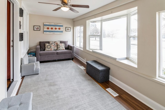 sunroom featuring ceiling fan