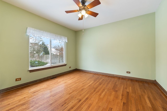 empty room featuring ceiling fan and light wood-type flooring