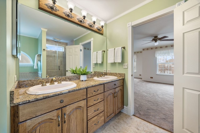 bathroom featuring walk in shower, vanity, ceiling fan, and crown molding