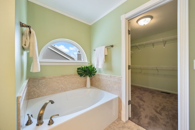 bathroom with a washtub and ornamental molding