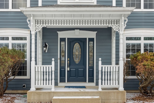 doorway to property featuring covered porch