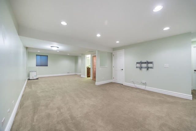 basement featuring light carpet