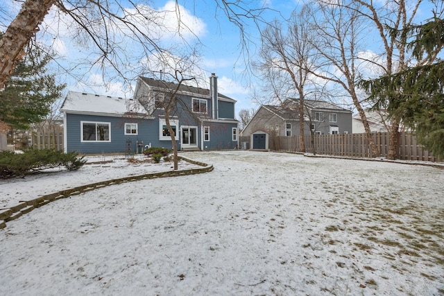 snow covered house with a shed