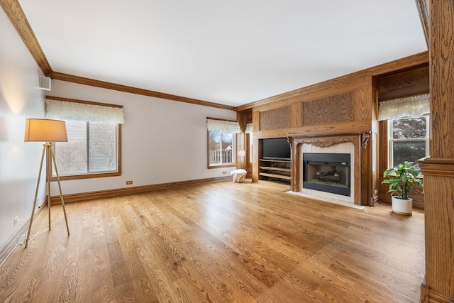 unfurnished living room featuring hardwood / wood-style floors and crown molding