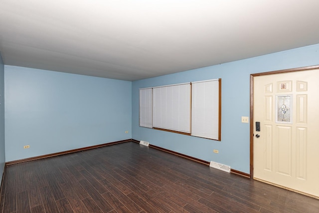 spare room featuring dark wood-type flooring